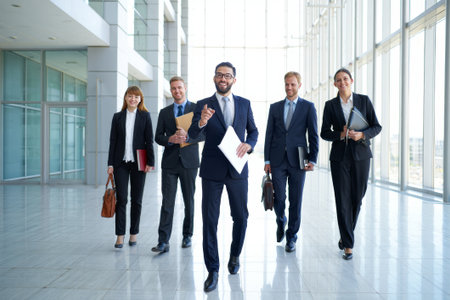 Group of business people walking in modern office with folder in hands.の写真素材