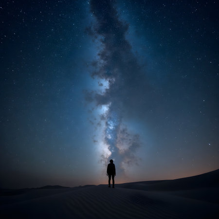 Man standing in the desert and looking at the milky way.の素材