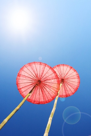 Thai traditional umbrella, with sun raysの写真素材