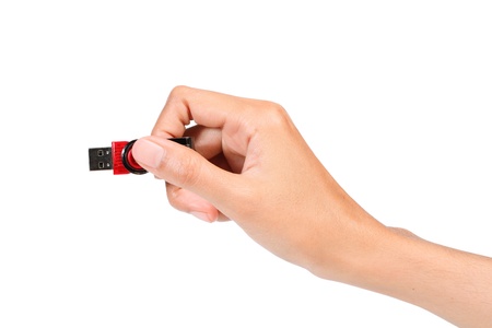 Hand holding USB device on white backgroundの写真素材
