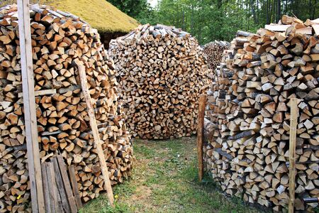 lumbered chopped firewood for the winter and piled in large packs. Melnsils, Kempings, Latvia 06 June 2019.のeditorial素材