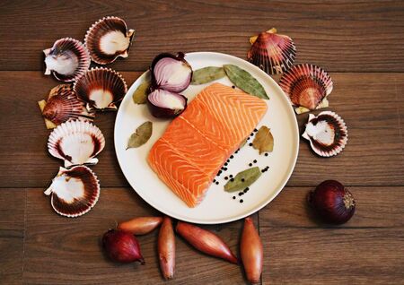A piece of fresh salted salmon on a plate ready for eating.の写真素材
