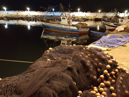 Small bots stand in the fishing port and the nets are dried on the pier. Skikda. Algeria. April 27, 2018.のeditorial素材