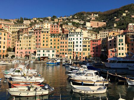 Many small boats in the Italian port of Komogli against the background of colorful houses on a sunny day. December 2017.のeditorial素材