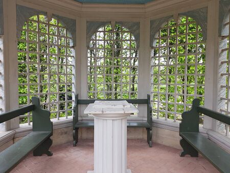 Wooden summer building with large open windows and benches inside for relaxing. Rundale Palace, Latvia, May 2019.のeditorial素材