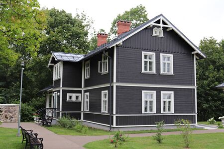 House is lined with wooden boards in the territory of Sigulda Castle. Latvia, July 2019.のeditorial素材