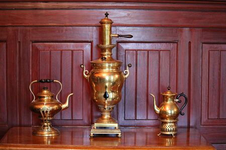 Two old copper teapots and a samovar in the Durbes manor on the outskirts of the Latvian city of Tukums in May 2019.のeditorial素材