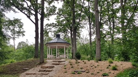 Wooden little arbor in a wooded park in the summer. Latvia, July 2019.のeditorial素材