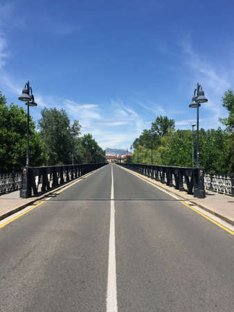 Road across a metal bridge stretching into the distance in the Spanish city of Logrono on June 22, 2019の写真素材