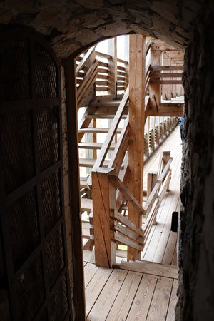 Stairs from thick wooden planks in the attic of an old building.の写真素材