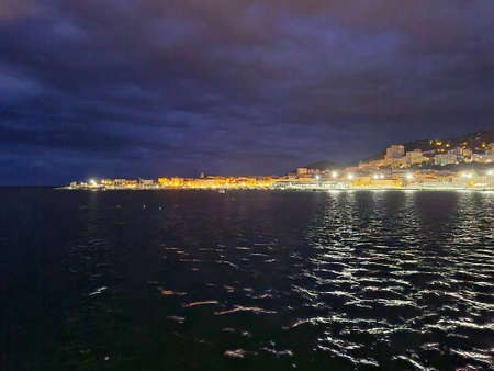 Glowing coast of the city of Bastia on the island of Corsica at night in February 2021.のeditorial素材