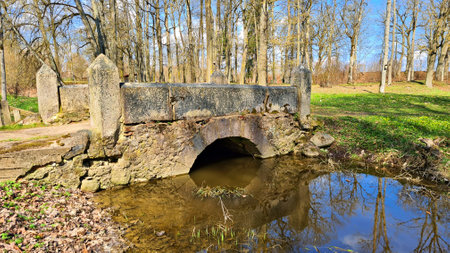 Small old stone bridge over stream on the outskirts of the villageの写真素材
