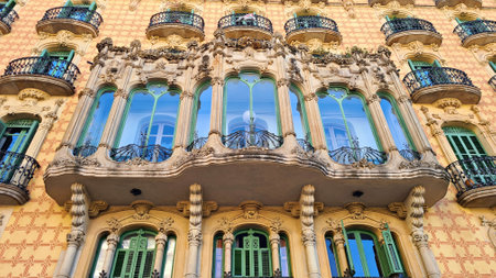 Facade of house with beautiful and unusual balcony in the Spanish city of Barcelona in the spring of...