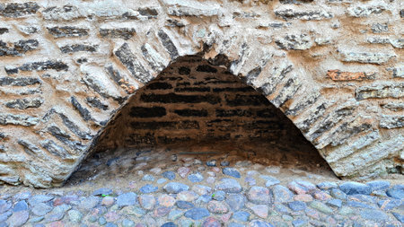 Triangular-shaped small niche at the base of stone fortress wallの写真素材