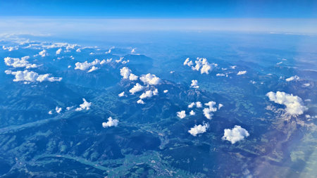 Beautiful endless panorama from the height of flying airplane above the cloudsの写真素材