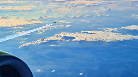 Beautiful endless panorama from the height of flying airplane above the clouds