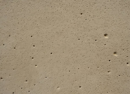 concrete with imperfections, weathered textured concrete surface, rugged concrete with pockmarks and voids, distressed grey concrete displaying weathered textures and imperfectionsの素材