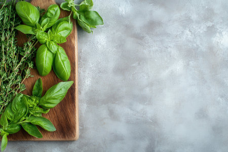 Herb basil display, Herbal assortment featuring vibrant basil leaves on natural wood background, Display of fresh basil herbs elegantly arranged on rustic wooden platter for visual appealの素材