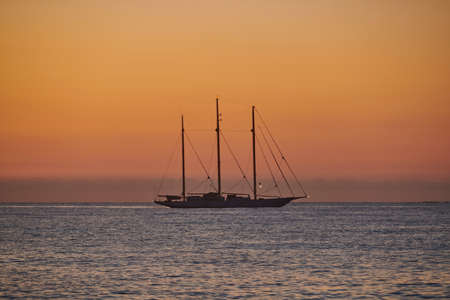 sailboat moored in the bay at dawn, sailing yacht at dawn in the bay