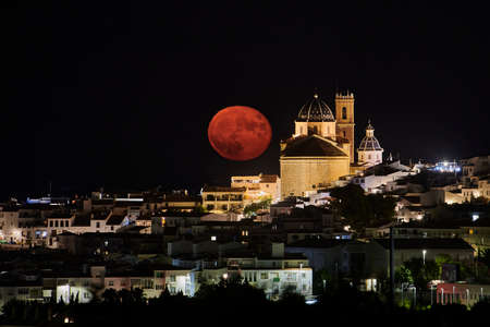 Full moon rise over town, in Atea, Alicante, Spain, full moon next to church, moon rise on the Costa...