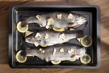 Fish with lemon slices in the panの写真素材