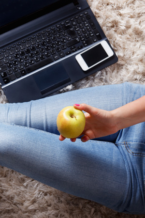 Close-up of an apple in the woman's handの写真素材