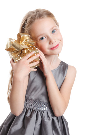 Beautiful child holding a gift isolatedの写真素材