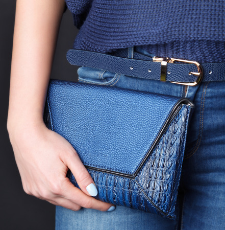 Close-up of a pretty leather envelope bag with matching nailsの写真素材