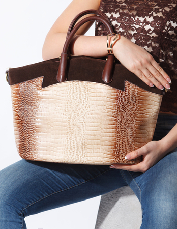 Closeup of a fashionable big gold woman bagの写真素材