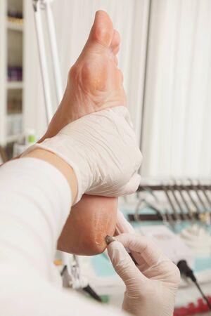 Young woman getting professional pedicure in beauty salonの写真素材