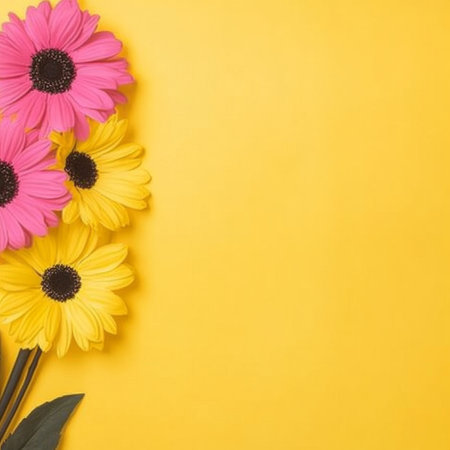 Pink and yellow flowers arranged against a sunny yellow backdropの素材