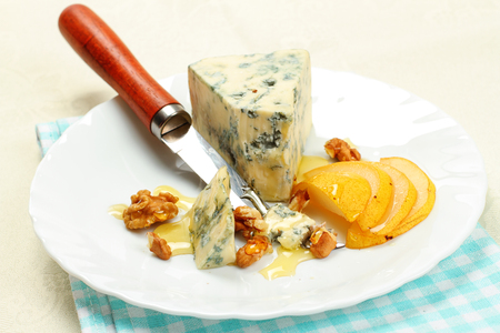 Pear, blue cheese and walnuts on a plateの写真素材
