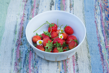 Organic garden strawberries in vintage bowlの写真素材