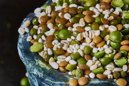 Assorted legumes and cereals on dark backgroundの写真素材