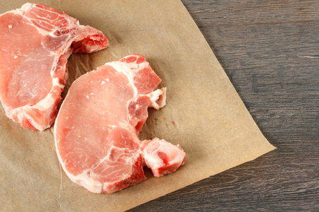 Raw pork steak on dark backgroundの写真素材