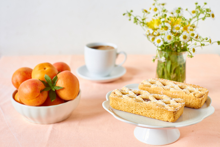 Rustic mini apricot tart on a summer tableの写真素材
