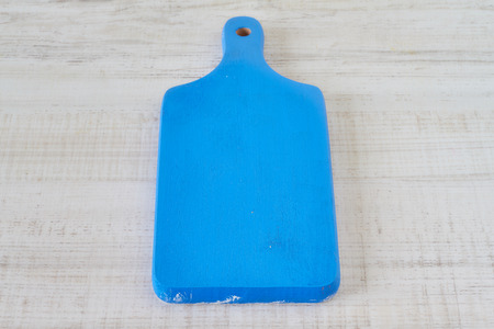 Vintage blue paint cutting board on wooden tableの写真素材