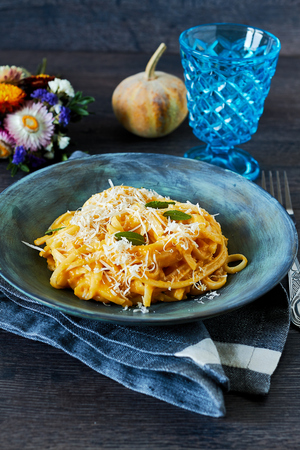 Creamy roasted butternut pumpkin pasta with parmesan cheese and sageの写真素材