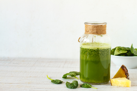 Homemade green smoothie with pineapple, spinach, nettle and gingerの写真素材