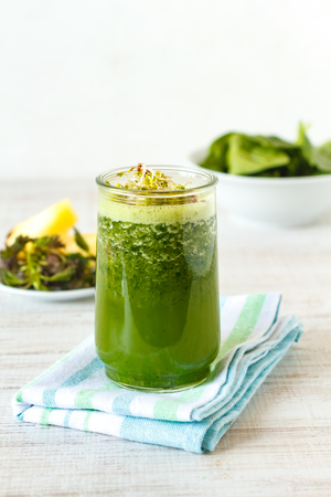 Homemade green smoothie with pineapple, spinach, nettle and gingerの写真素材