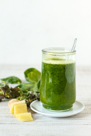 Homemade green smoothie with pineapple, spinach, nettle and gingerの写真素材