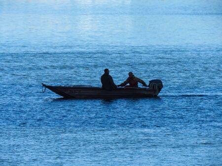 The fishermen on the boat collecting net.の写真素材