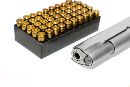 Automatic gun pistol with bullet box in white backgroundの写真素材