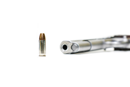 Bullet with blur automatic gun pistol white backgroundの写真素材