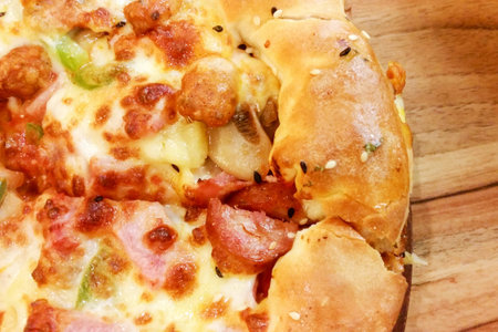 Close up delicious tasty pizza food with cheese bacon ham toppingの写真素材