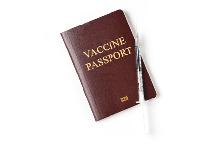 Vaccine passport with medical syringe needle dose with drug. Vaccination passport is concept of immune travel to protect from Covid-19 virus pandemic on white backgroundの写真素材