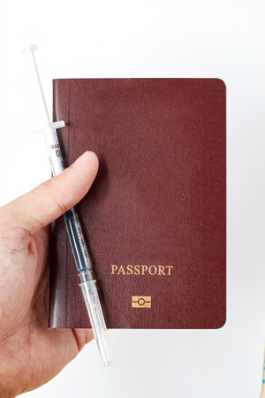 Vaccine passport with medical syringe needle dose with drug. Vaccination passport is concept of immune travel to protect from Covid-19 virus pandemic on white backgroundの写真素材