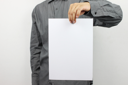 Businessmen Hold Blank white Paper and have copy space to design in your business work.の写真素材