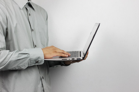 business man is holding a computer laptop for his work.