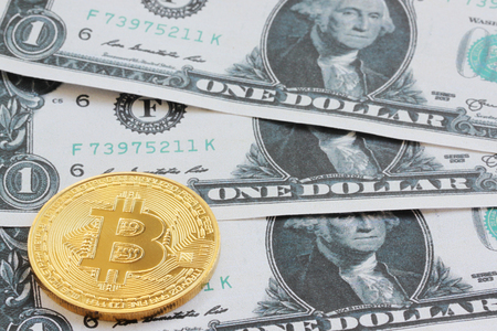 A bit coin is placed on bank notes background for business concepts and have copy space for you.の写真素材